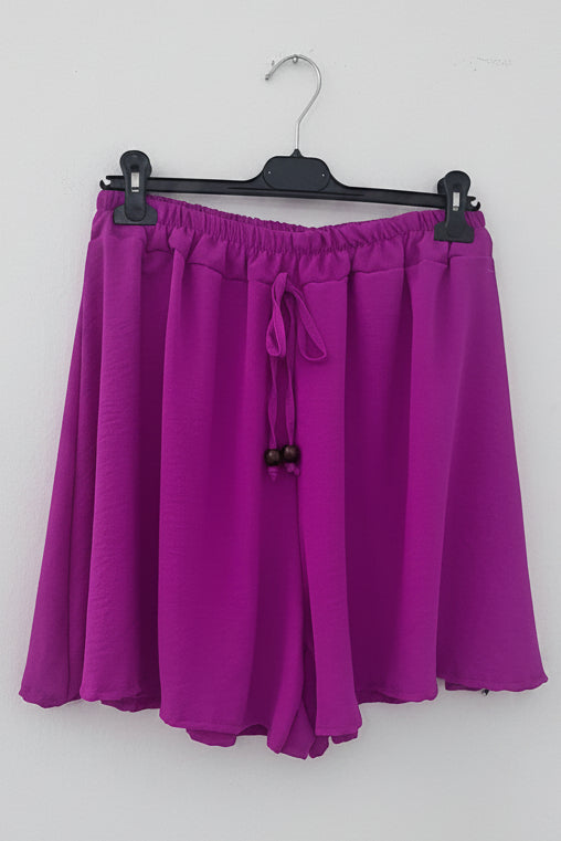 Shorts gonna viola con laccetto e nappine