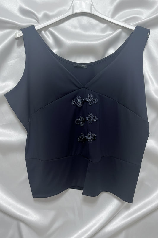 Top senza maniche nero con chiusure a nodo decorative e scollo a V