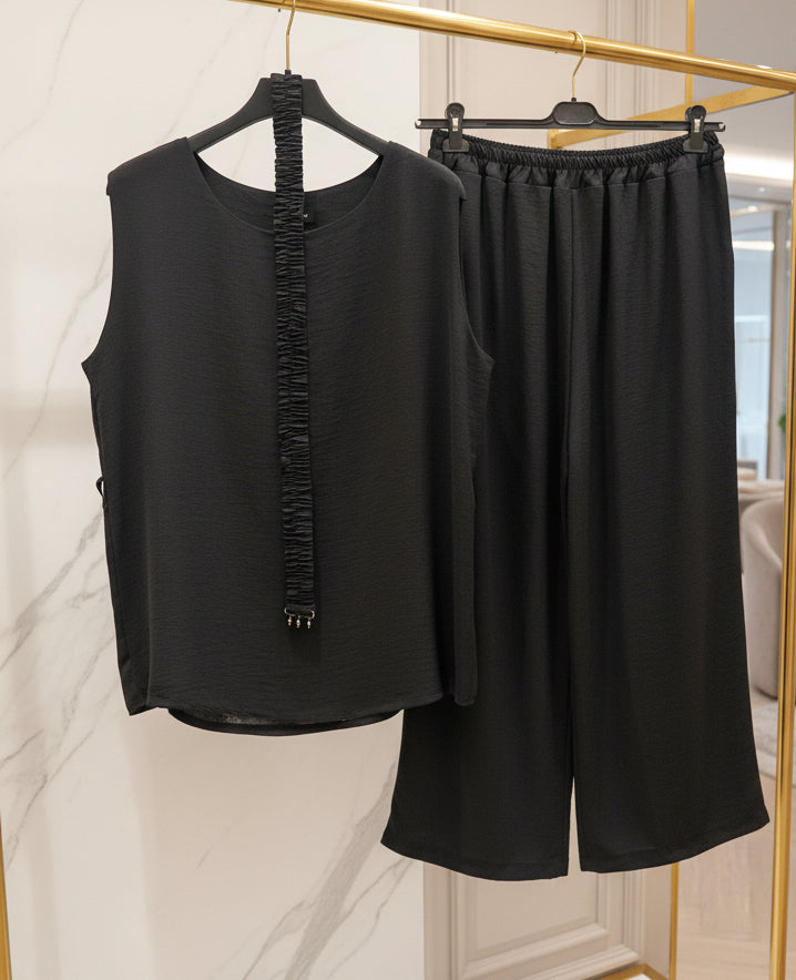 Completo top e pantaloni culotte neri tinta unita