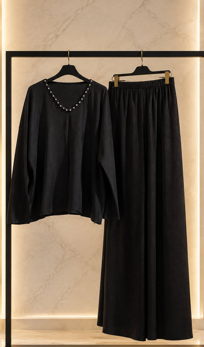 Completo nero con maglia a scollo decorato e pantaloni ampi